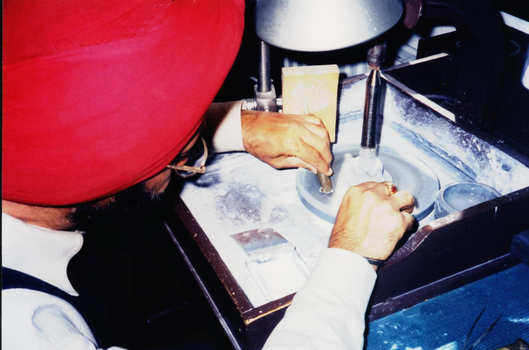 Parambir Makhni cutting gemstones at the lapidary wheel
