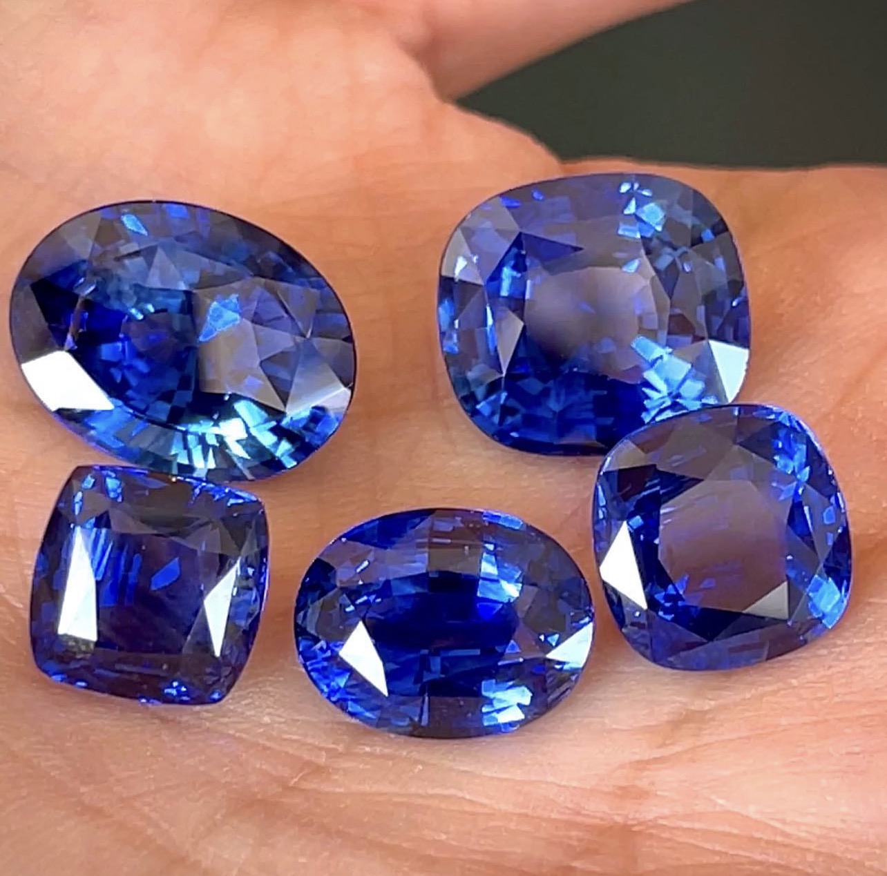 Five fine blue sapphires in oval and cushion cuts