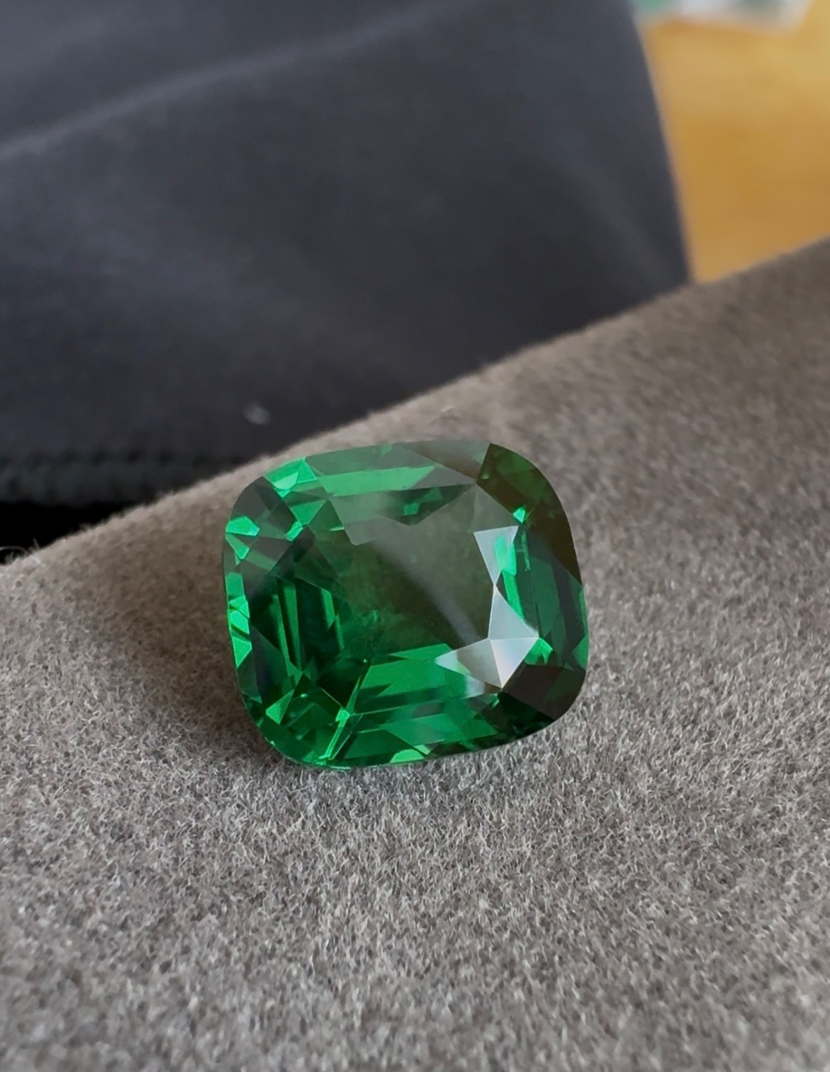 A vivid cushion-cut tsavorite